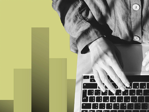 Black-and-white photo of a person’s hand resting on a laptop keyboard, wearing a long-sleeve button-up shirt, set against a light green background with abstract vertical bar shapes.