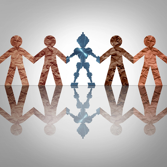 Five paper-cutout figures stand hand in hand on a reflective surface. Four are brown, while the central figure is blue and robotic, suggesting technology or AI among humans. A soft gray background emphasizes unity and contrast between humans and machines.