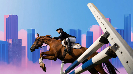 A horse and rider in equestrian gear leap over a striped jump against a backdrop of tall, colorful city buildings and a bright blue sky with pink accents, symbolizing ambition and overcoming challenges.